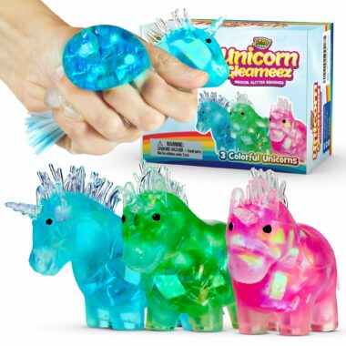 Three unicorn squishy stress toys in blue, green, and pink with their packaging, and a hand squeezing one of them.